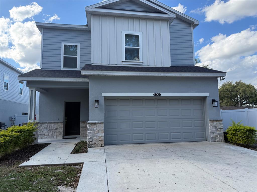 4920 8th Street Zephyrhills, FL 33542 - Photo 2 of 57 a front view of a house with a yard and garage
