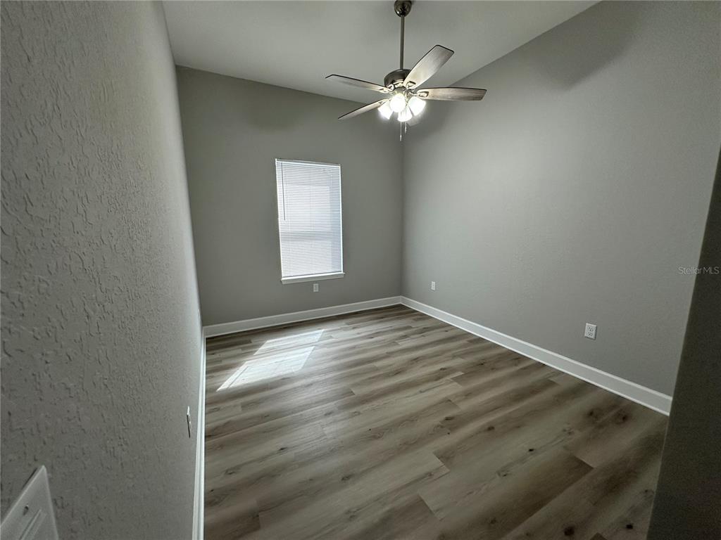 4920 8th Street Zephyrhills, FL 33542 - Photo 42 of 57 an empty room with wooden floor and windows