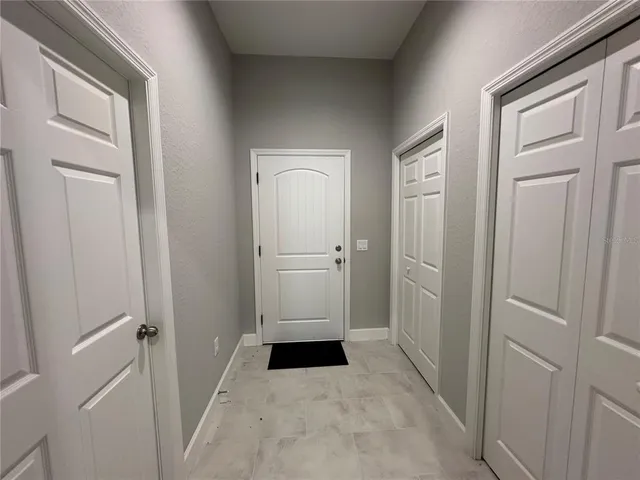 a kitchen with granite countertop a sink a stove oven and refrigerator