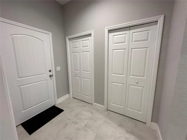 a kitchen with stainless steel appliances granite countertop white cabinets and a stove a oven with white countertops