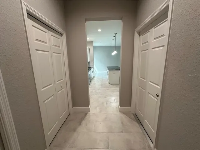 a bathroom with a granite countertop sink a toilet and mirror