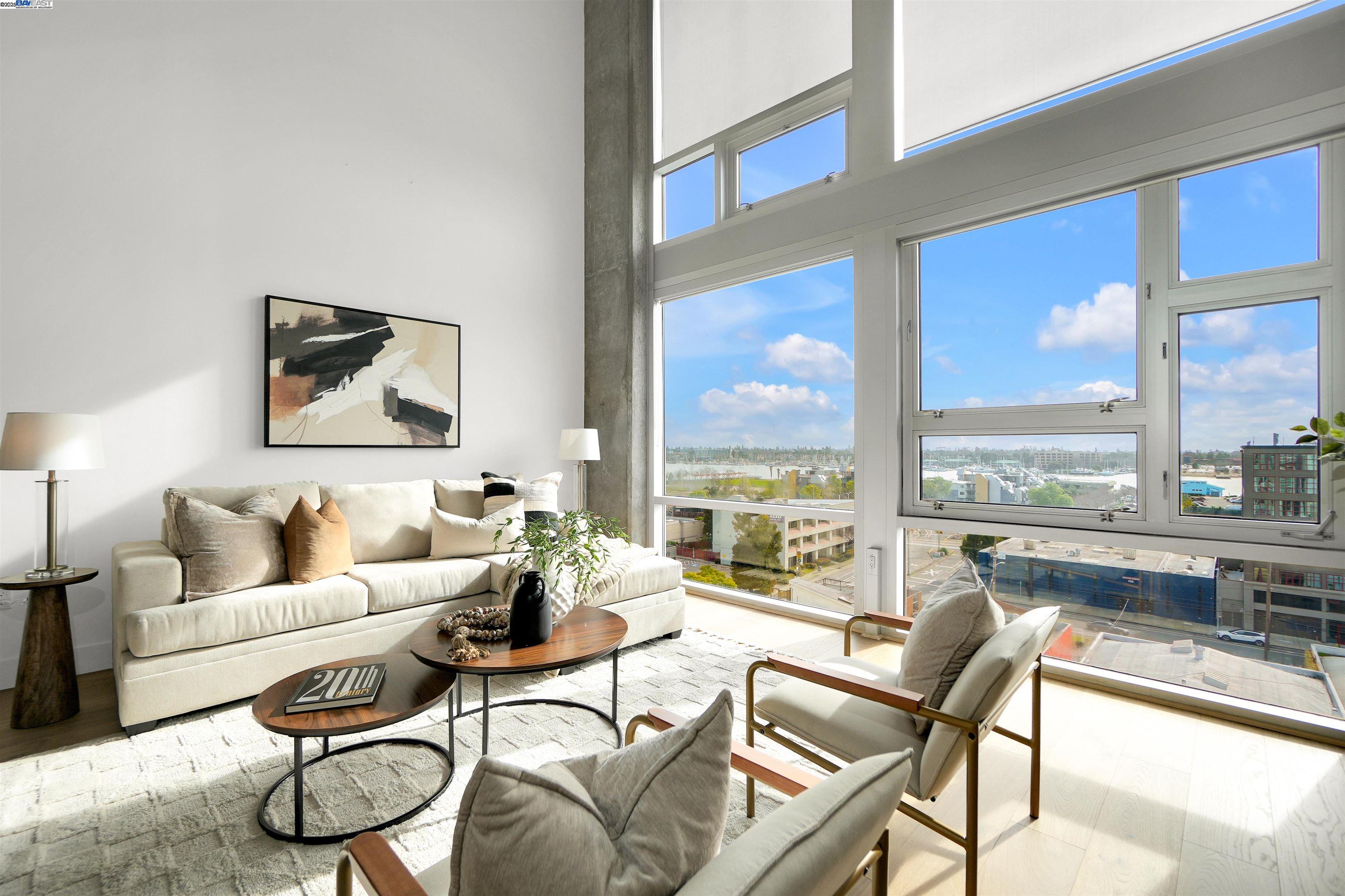 311 Oak Street, Unit PH25 Oakland, CA 94607 - Photo 1 of 14 a living room with furniture and a large window