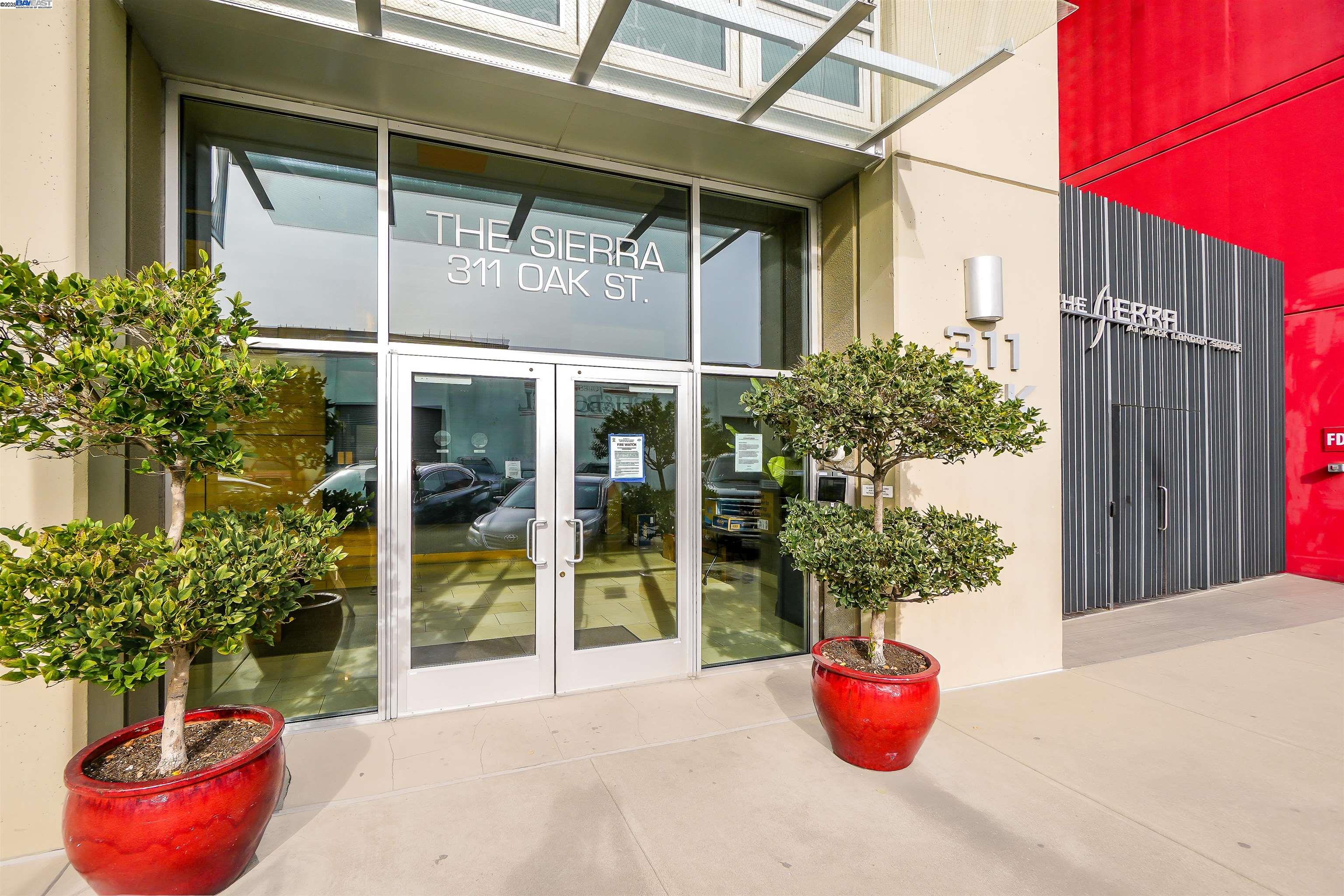 311 Oak Street, Unit PH25 Oakland, CA 94607 - Photo 11 of 14 a view of a potted plant sitting in front of a glass door