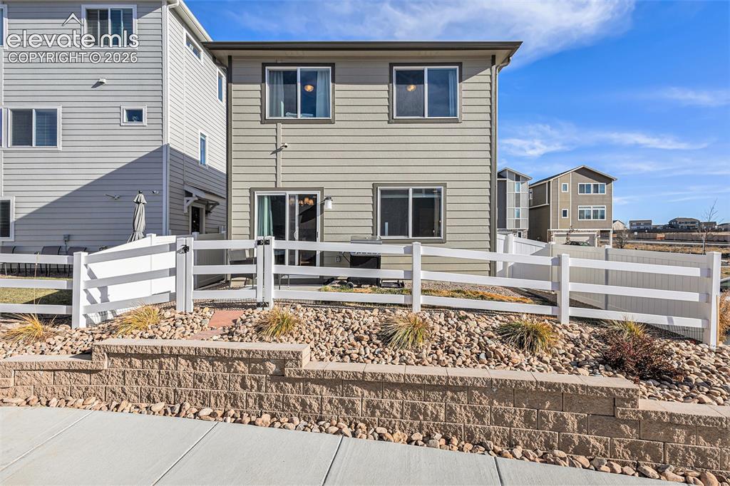 2940 Magic Carpet Loop Colorado Springs, CO 80916 - Photo 4 of 21 a white building with a bench in front of it