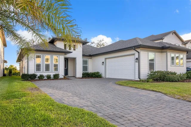 a front view of a house with a garden and yard