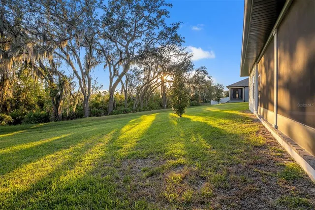 a view of yard with swimming pool and trees
