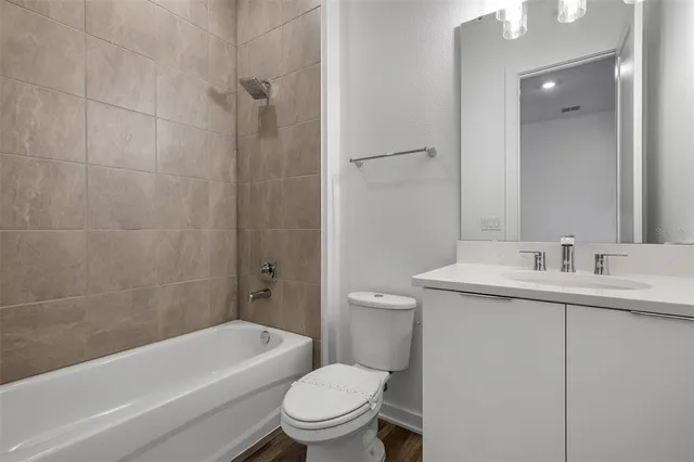 a bathroom with a toilet a sink and bathtub