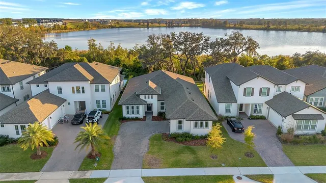 an aerial view of houses with a lake