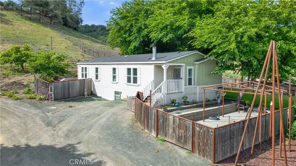 a kitchen with granite countertop a refrigerator a stove a sink dishwasher a dining table and chairs with wooden floor