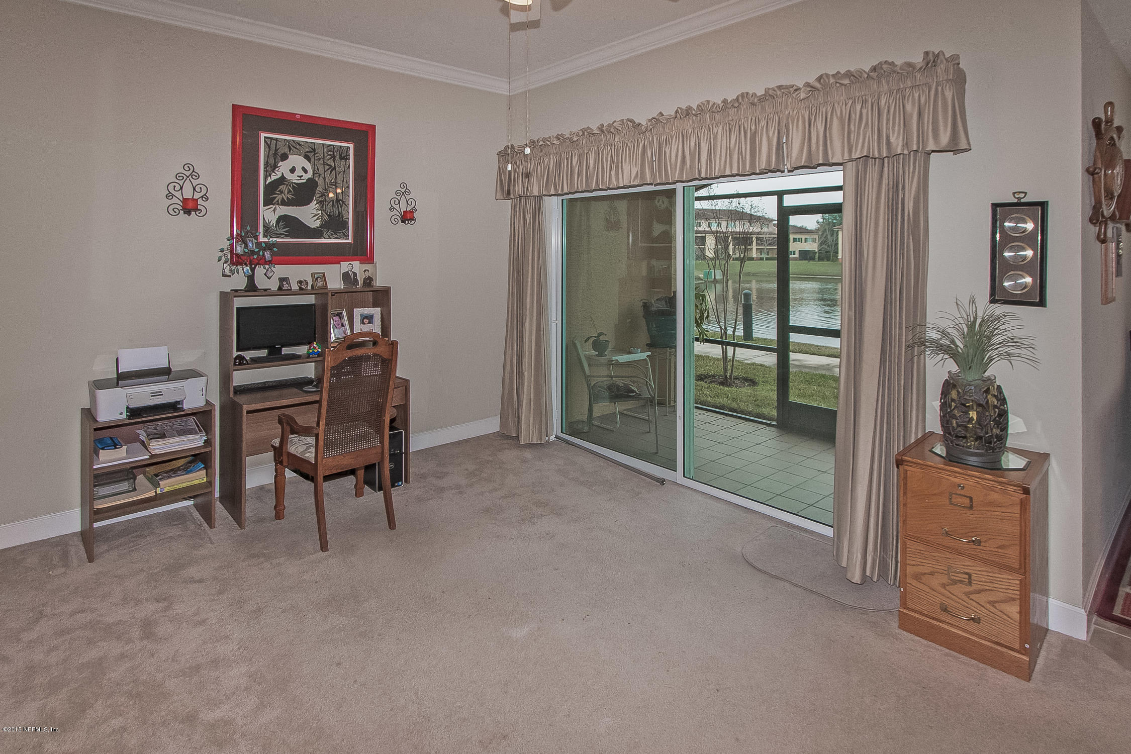 9745 Touchton Road, Unit 3103 Jacksonville, FL 32246 - Photo 14 of 20 a view of a livingroom with furniture and a flat screen tv