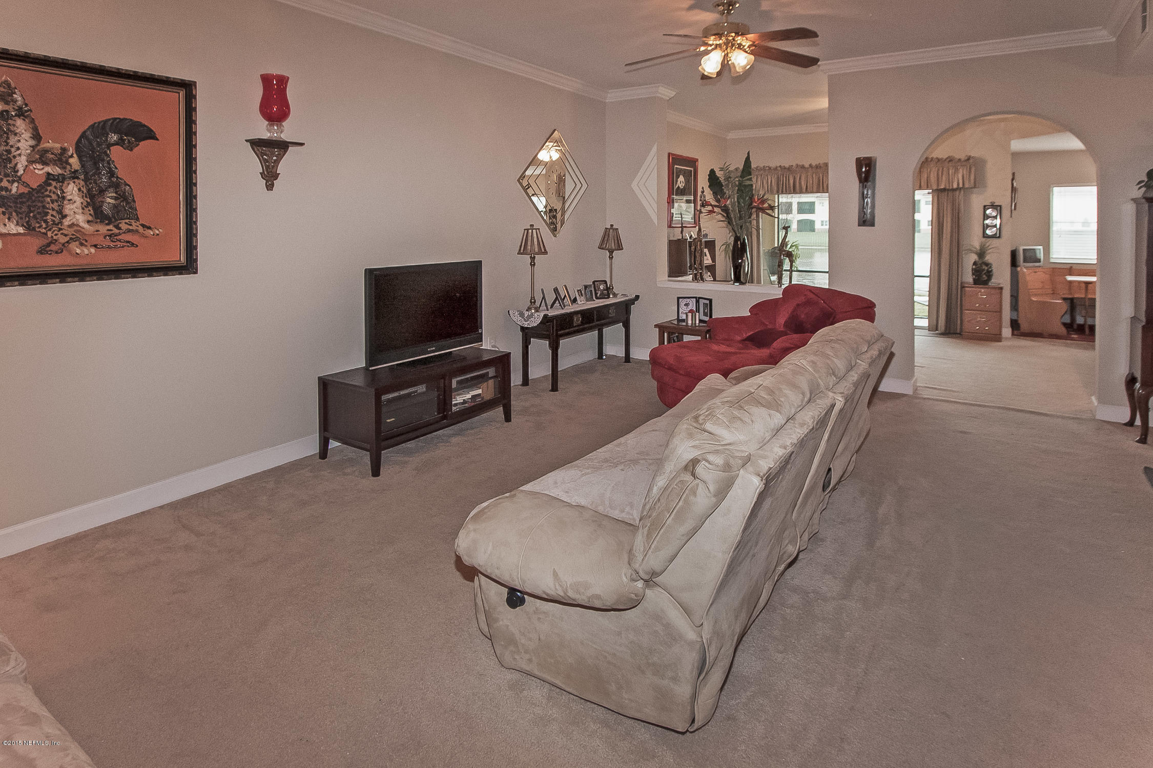 9745 Touchton Road, Unit 3103 Jacksonville, FL 32246 - Photo 19 of 20 a living room with furniture and a flat screen tv