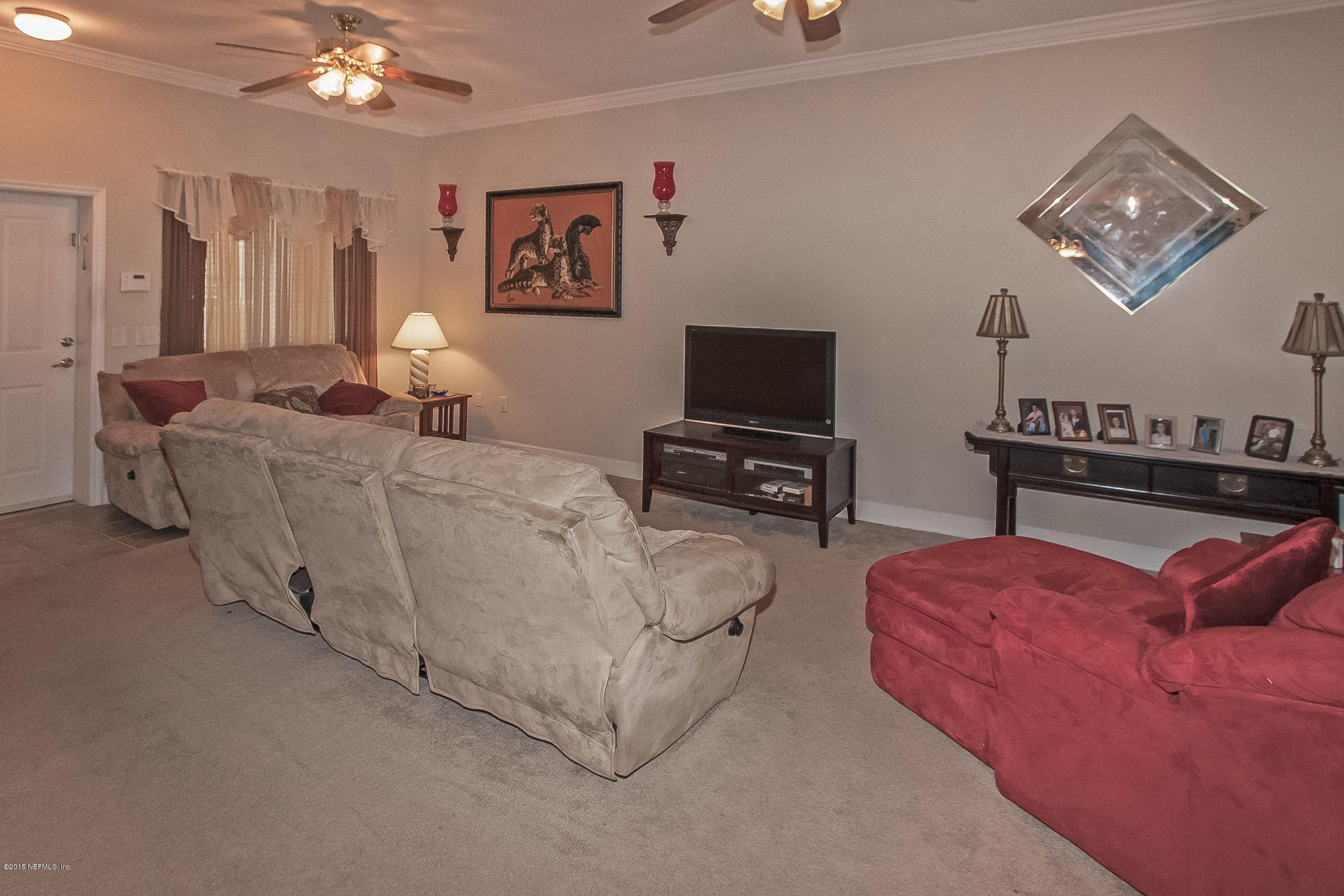 9745 Touchton Road, Unit 3103 Jacksonville, FL 32246 - Photo 20 of 20 a living room with furniture a flat screen tv and a lamp