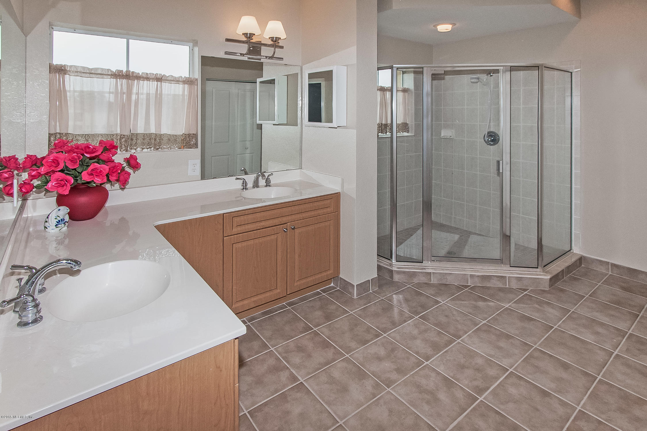 9745 Touchton Road, Unit 3103 Jacksonville, FL 32246 - Photo 2 of 20 a bathroom with a sink shower and a mirror