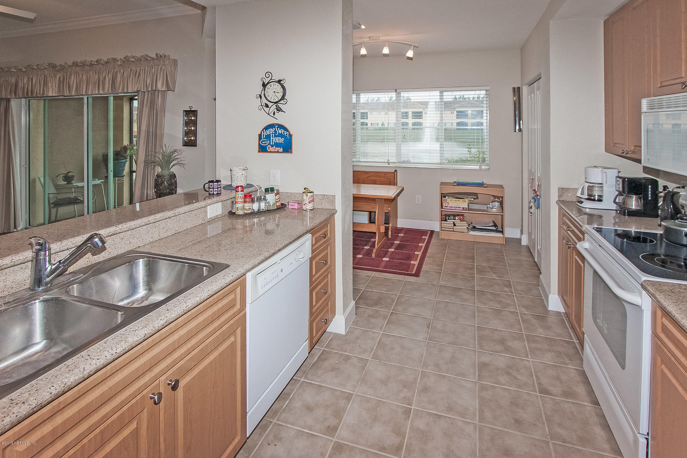 9745 Touchton Road, Unit 3103 Jacksonville, FL 32246 - Photo 3 of 20 a kitchen with a sink stove and cabinets