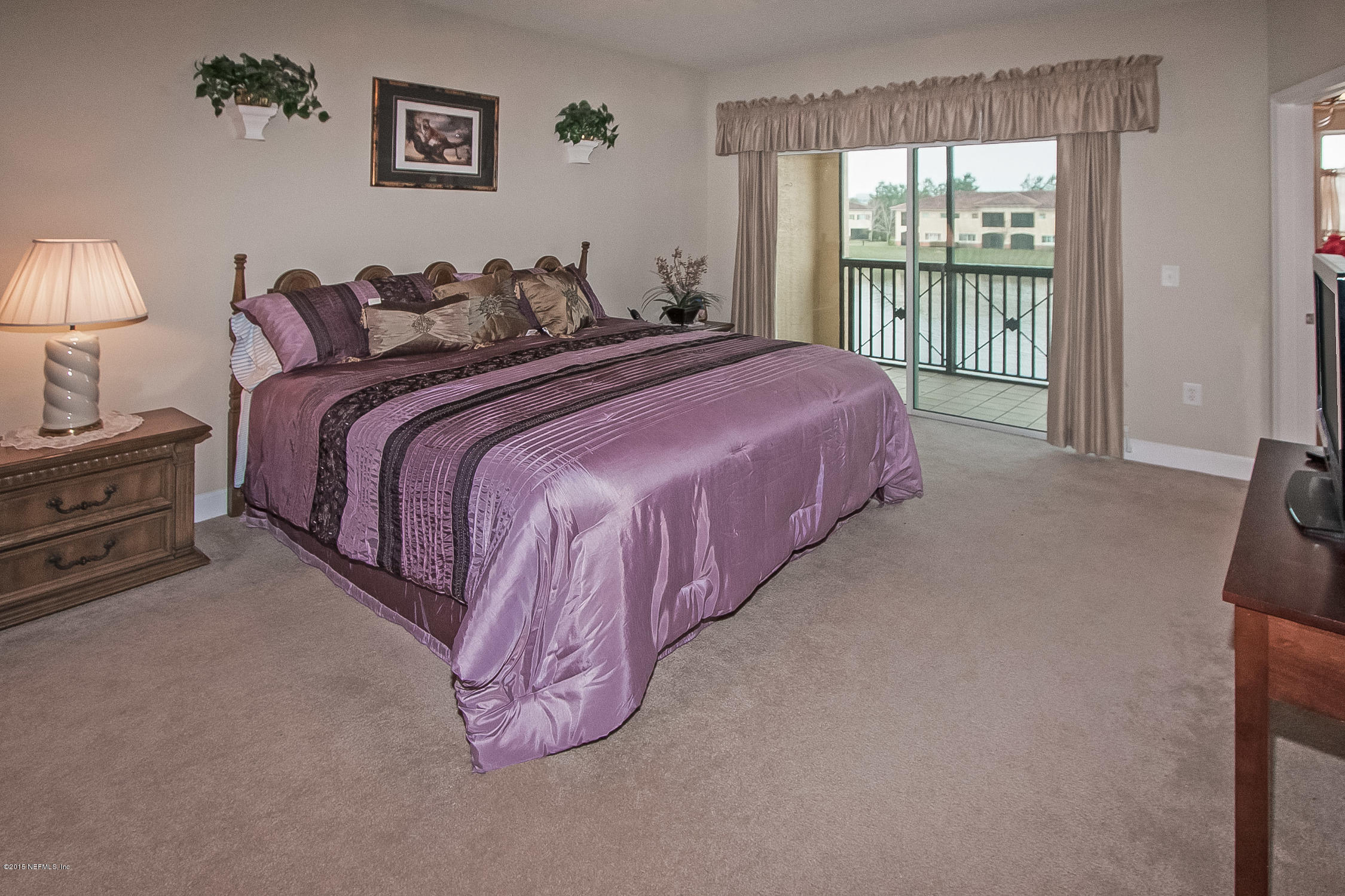 9745 Touchton Road, Unit 3103 Jacksonville, FL 32246 - Photo 5 of 20 a spacious bedroom with a bed and a large window
