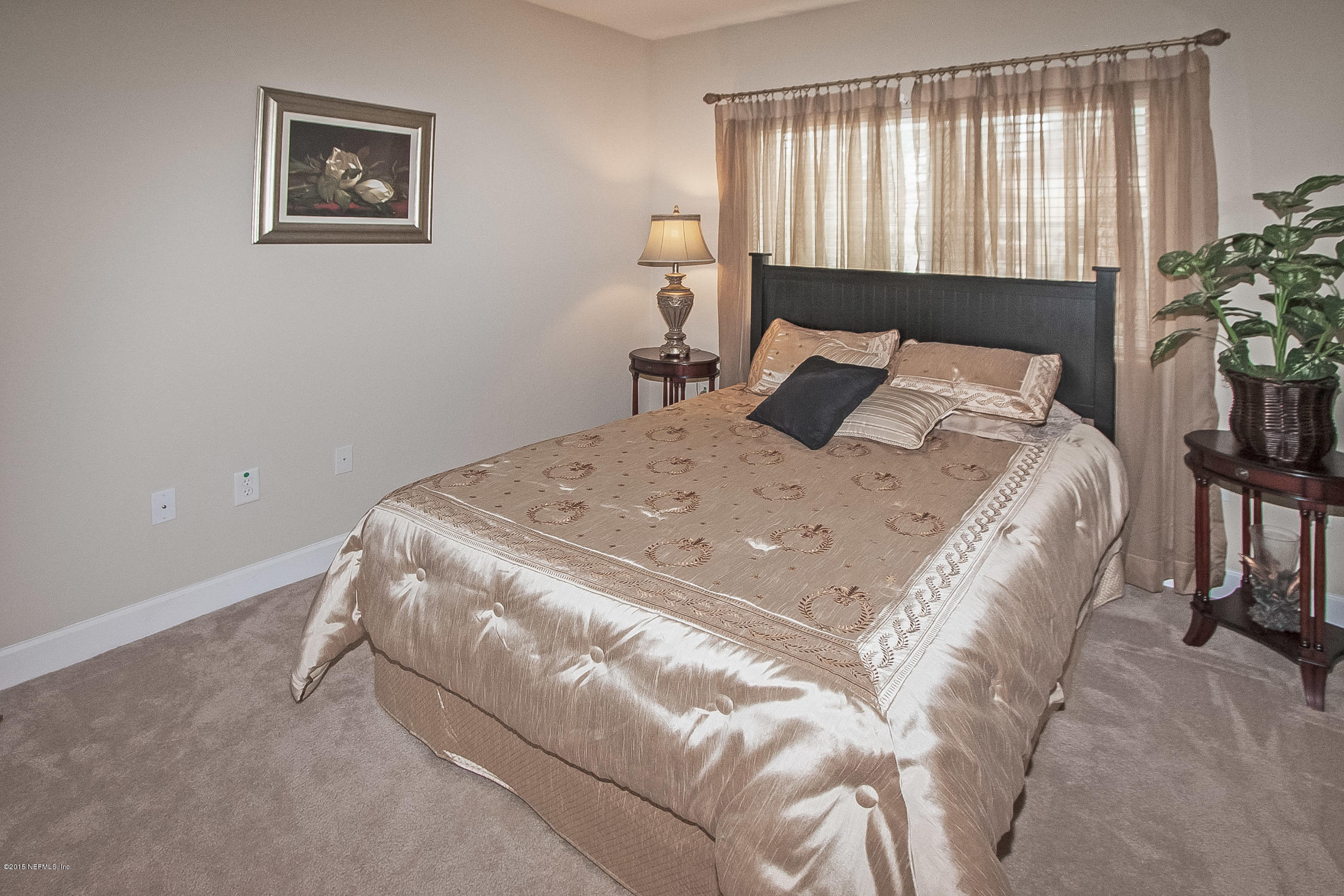 9745 Touchton Road, Unit 3103 Jacksonville, FL 32246 - Photo 9 of 20 a bed sitting in a bedroom next to a window