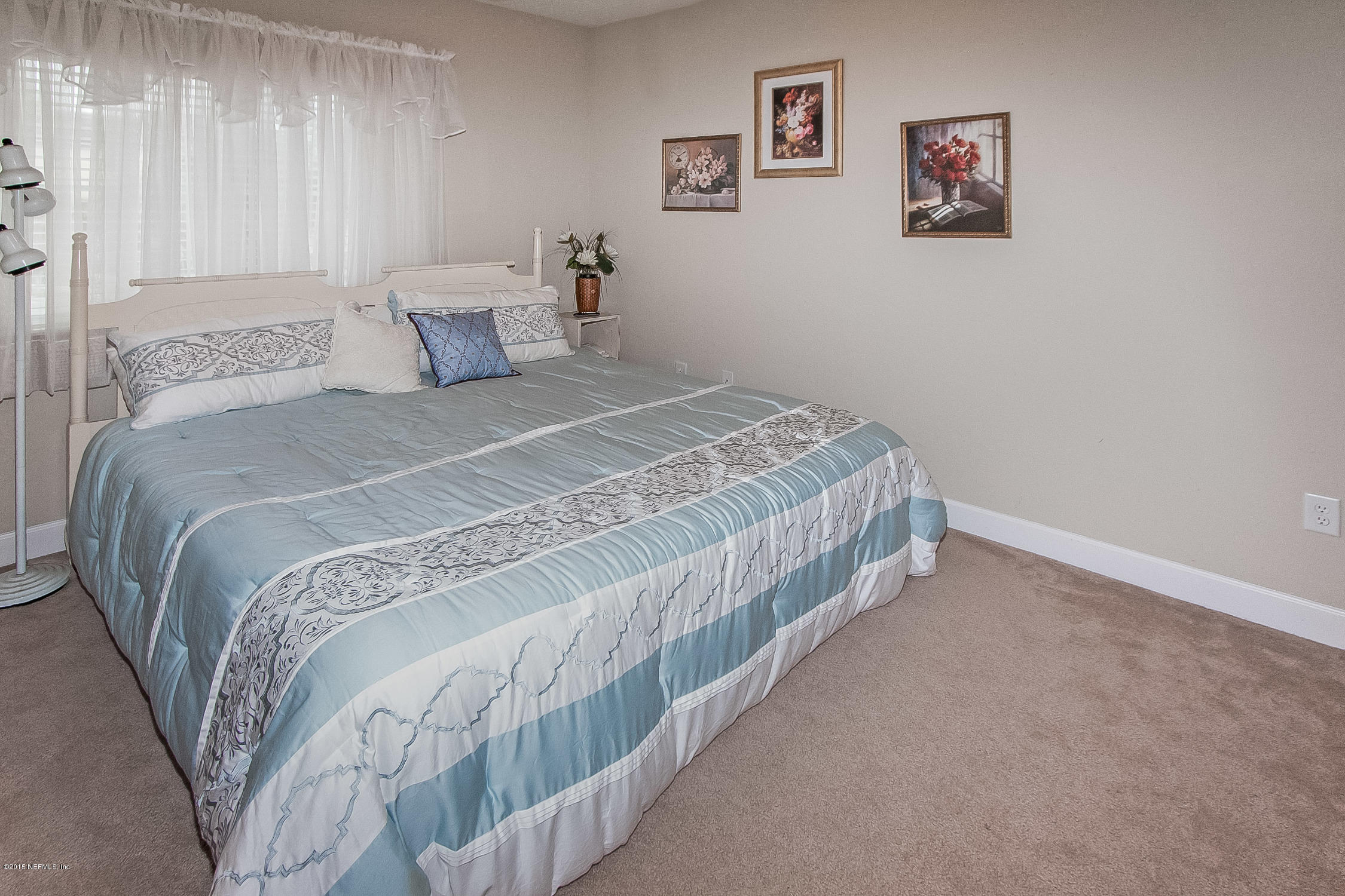 9745 Touchton Road, Unit 3103 Jacksonville, FL 32246 - Photo 10 of 20 a bedroom with a bed and painting on the wall