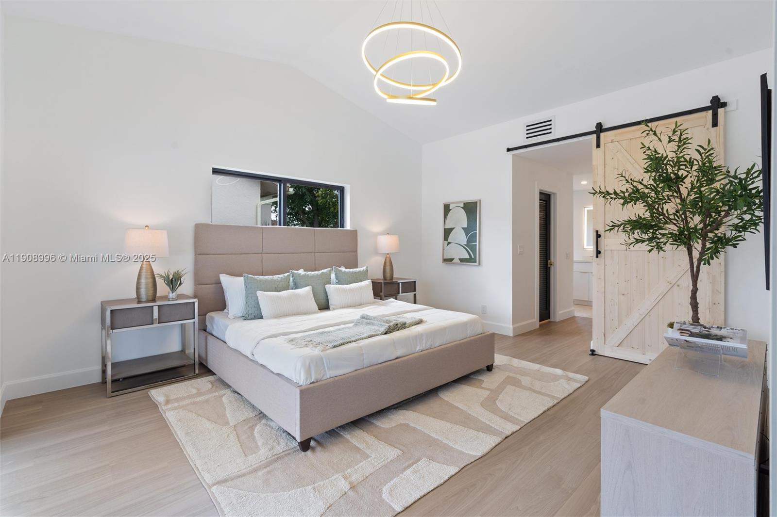 4108 Cedar Creek Road Boca Raton, FL 33487 - Photo 12 of 36 a spacious bedroom with a bed and a flat screen tv