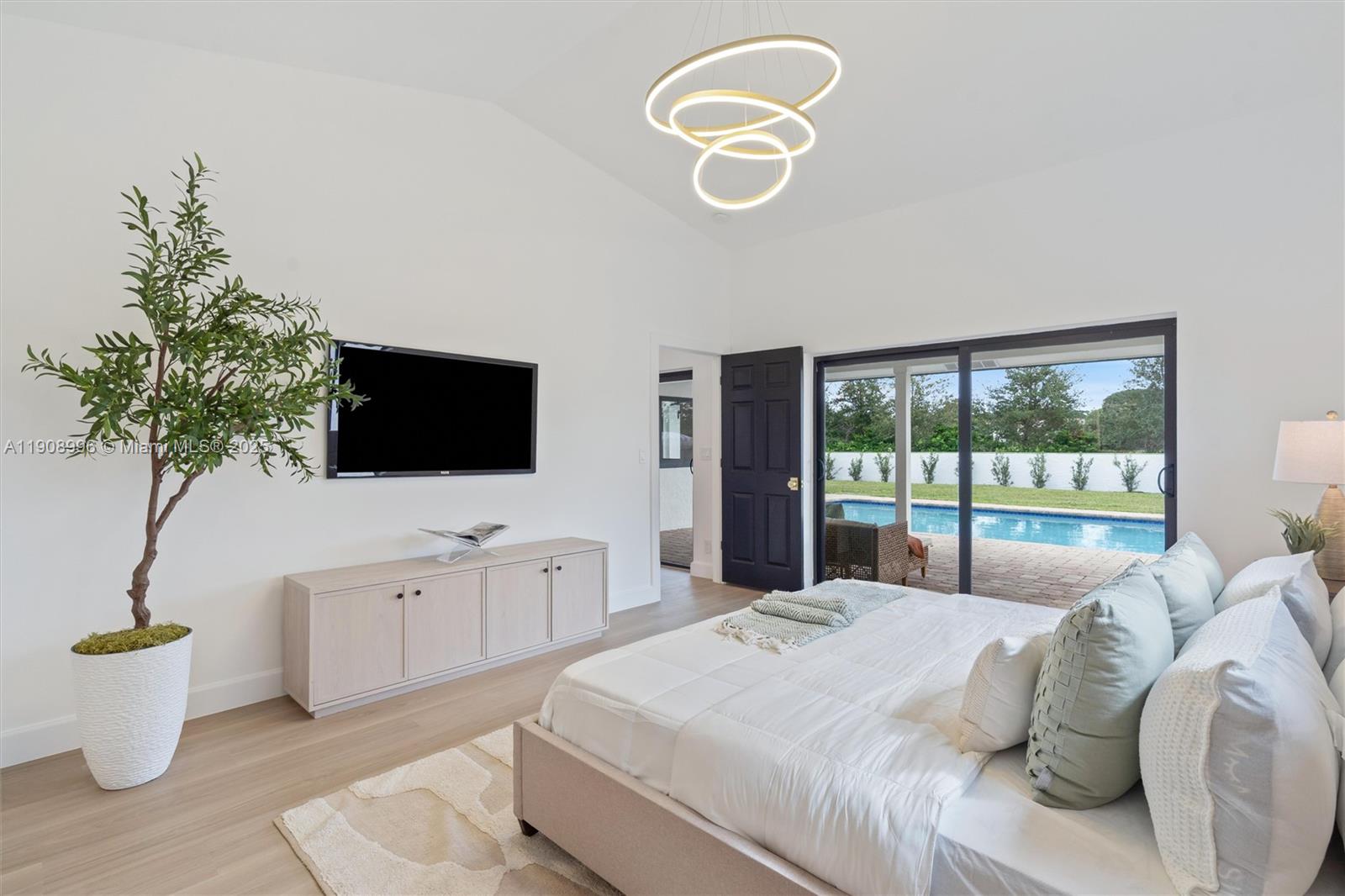 4108 Cedar Creek Road Boca Raton, FL 33487 - Photo 13 of 36 a bedroom with a bed and a flat screen tv