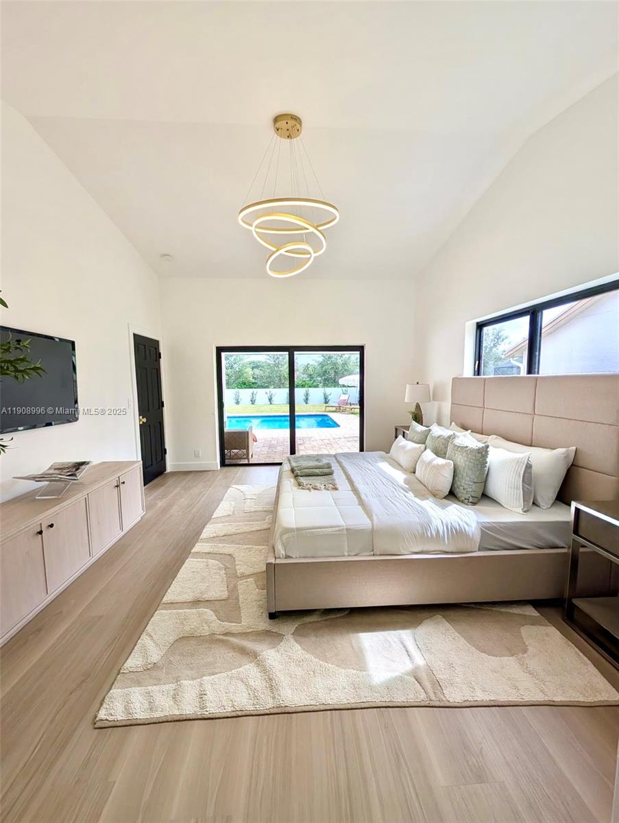 4108 Cedar Creek Road Boca Raton, FL 33487 - Photo 14 of 36 a bedroom with a large bed and a large window