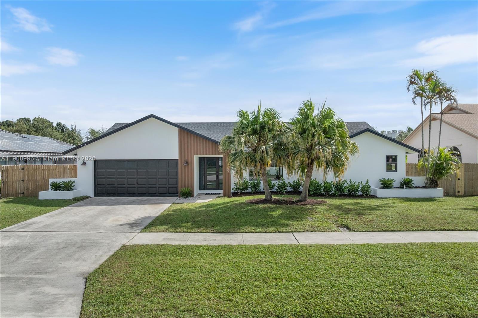 4108 Cedar Creek Road Boca Raton, FL 33487 - Photo 2 of 36 a front view of house with yard and green space