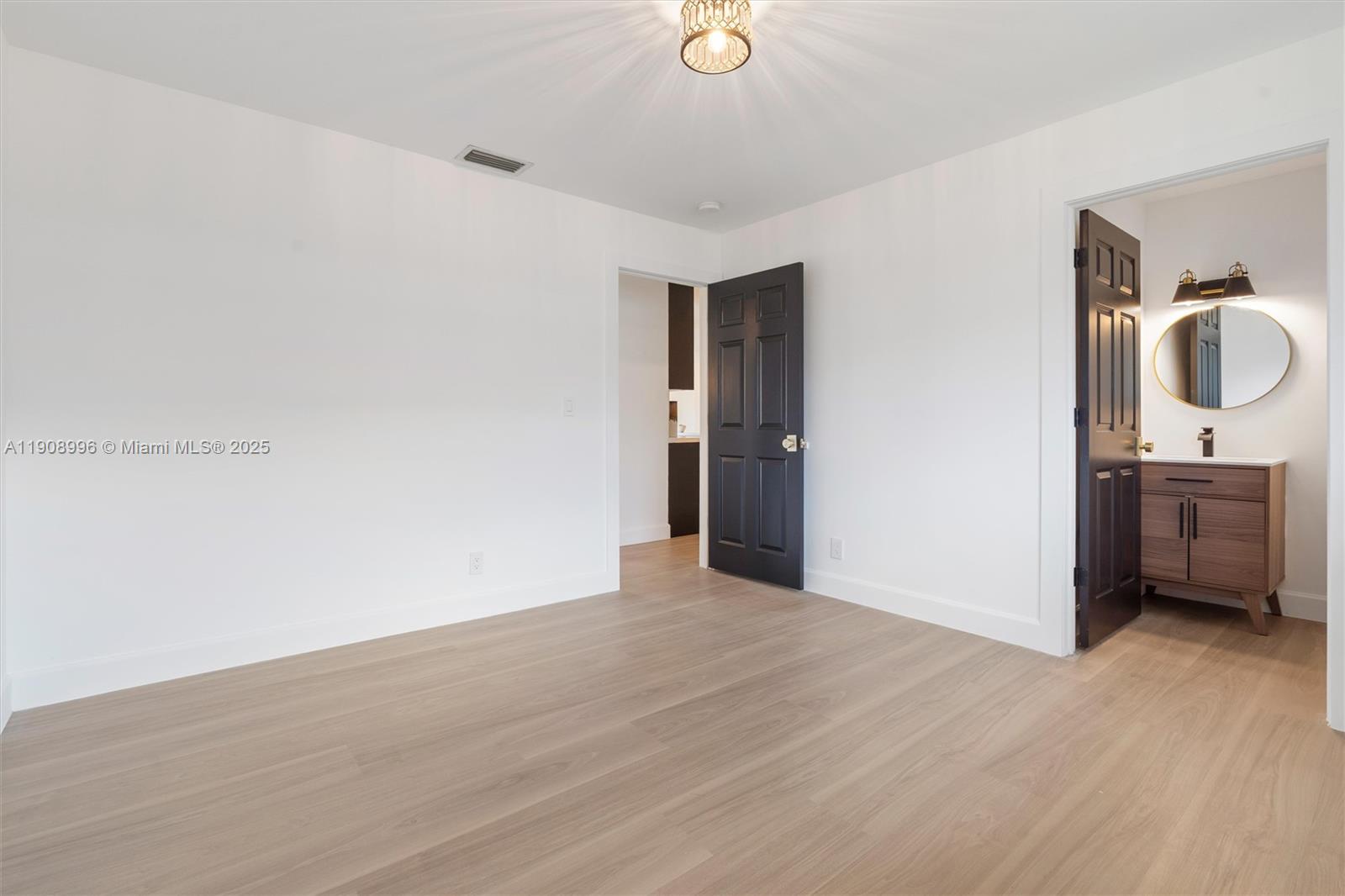 4108 Cedar Creek Road Boca Raton, FL 33487 - Photo 22 of 36 a view of a room with wooden floor and bathroom