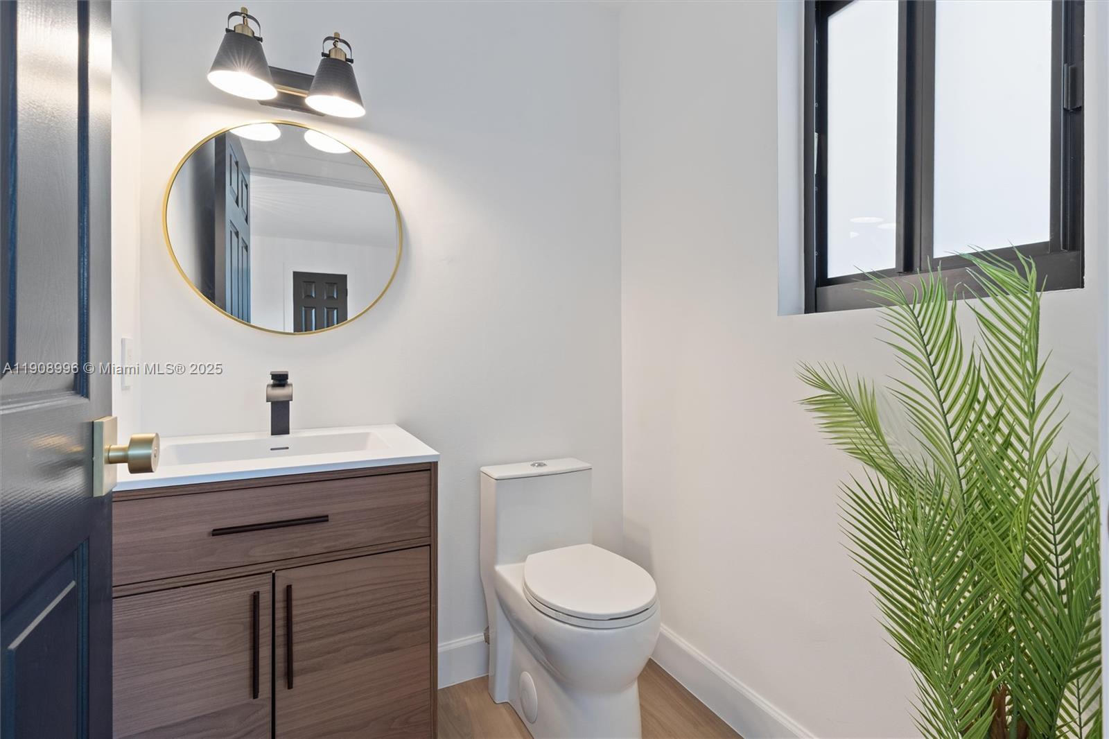4108 Cedar Creek Road Boca Raton, FL 33487 - Photo 23 of 36 a bathroom with a toilet sink and mirror