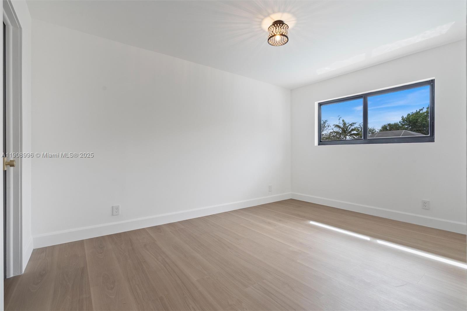 4108 Cedar Creek Road Boca Raton, FL 33487 - Photo 24 of 36 an empty room with a painting on the wall