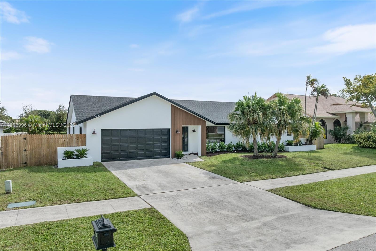 4108 Cedar Creek Road Boca Raton, FL 33487 - Photo 3 of 36 a front view of house with yard and green space