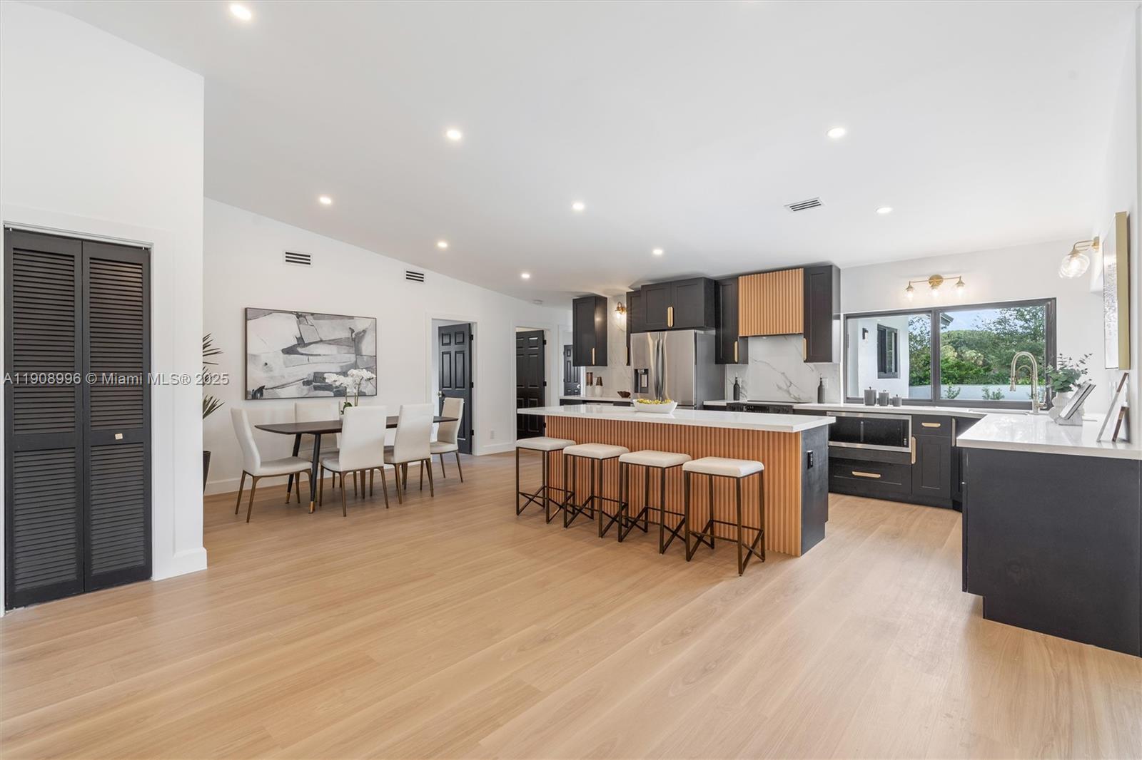 4108 Cedar Creek Road Boca Raton, FL 33487 - Photo 8 of 36 a large kitchen with a table and chairs in it