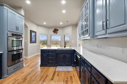 a kitchen with stainless steel appliances granite countertop a stove and cabinets