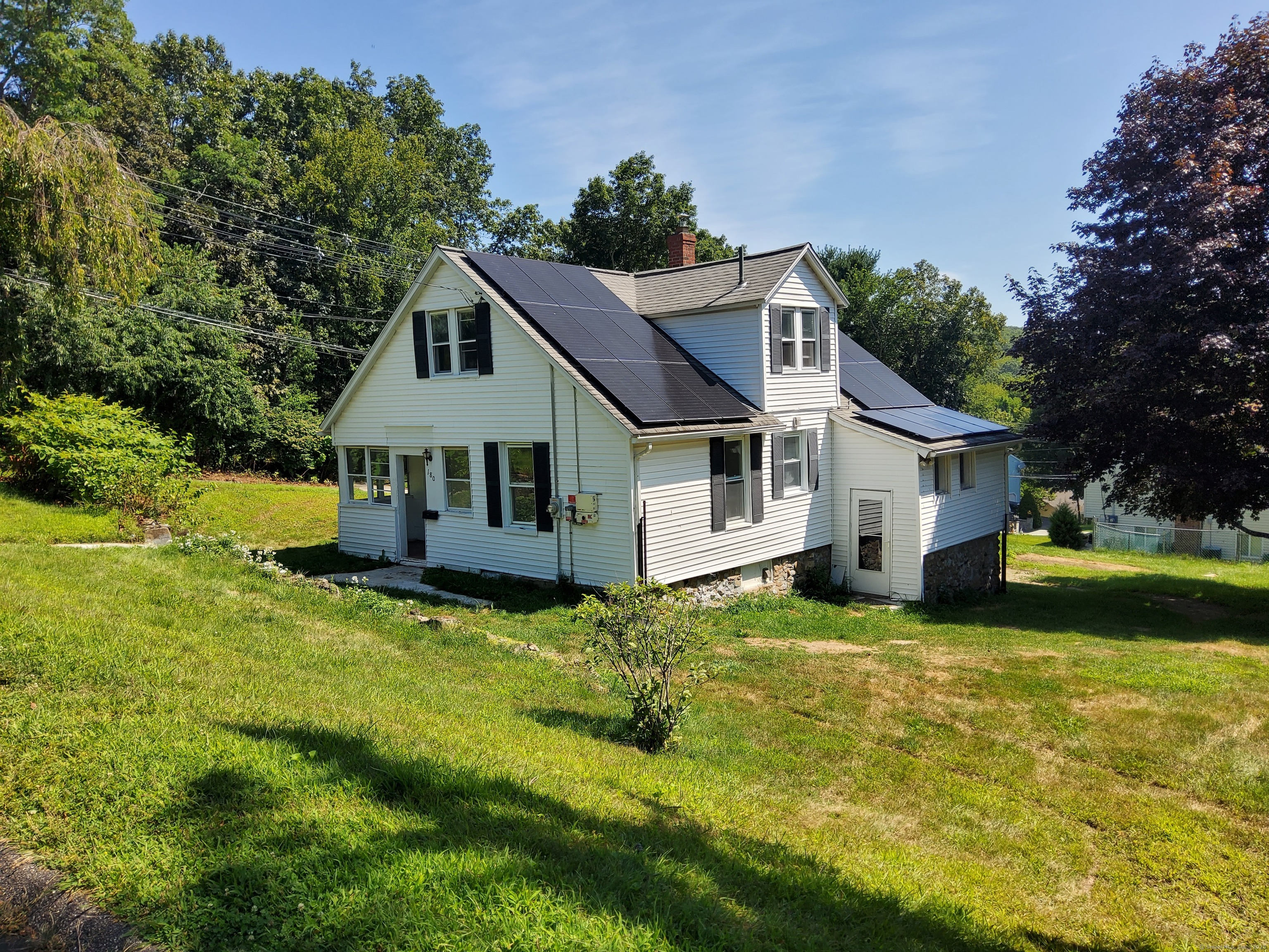 a front view of a house with yard and green space