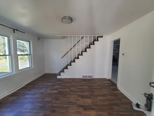 a view of entryway and hall with wooden floor