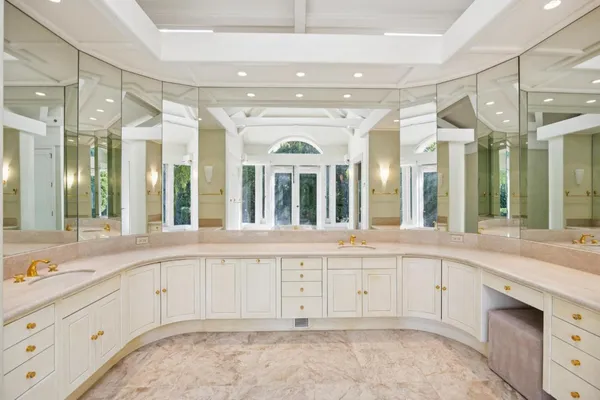 a large white kitchen with a large window