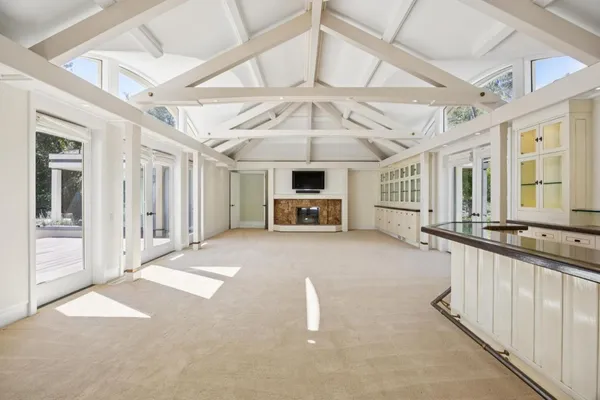 a living room with furniture and a chandelier