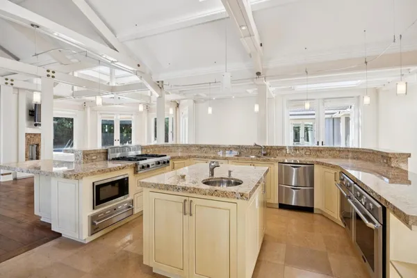 a kitchen with a stove sink and cabinets