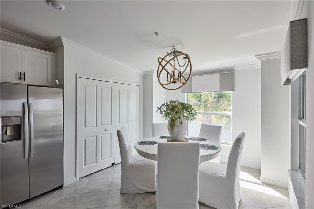 6070 National Blvd Avenue, Unit 226 Immokalee, FL 34142 - Photo 13 of 47 a dining room with furniture potted plants and wooden floor