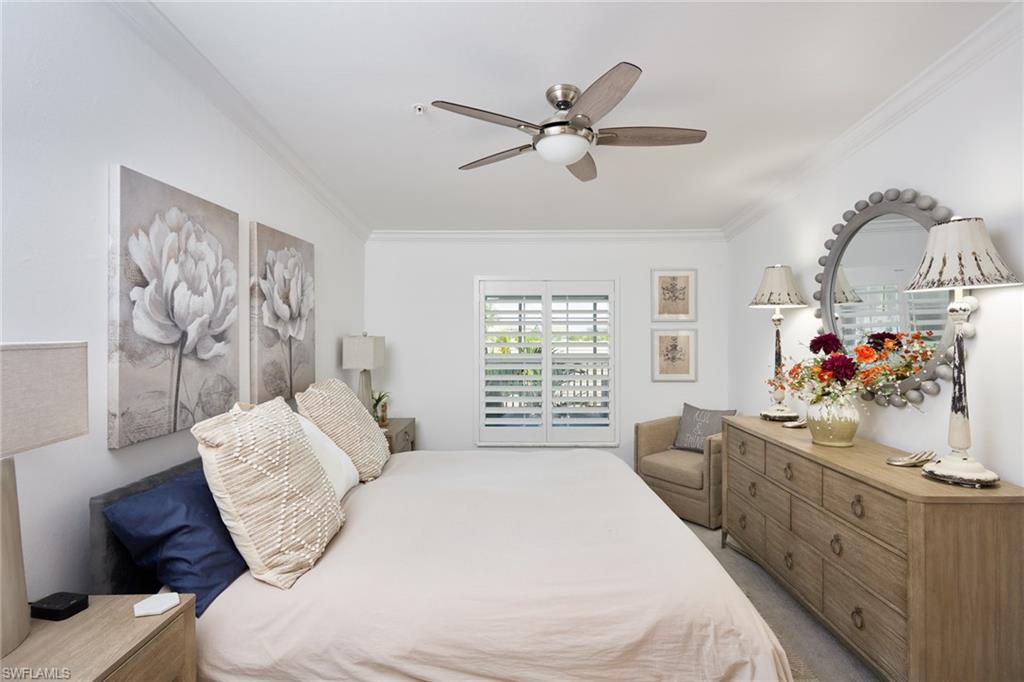 6070 National Blvd Avenue, Unit 226 Immokalee, FL 34142 - Photo 21 of 47 a bedroom with a bed and a chandelier