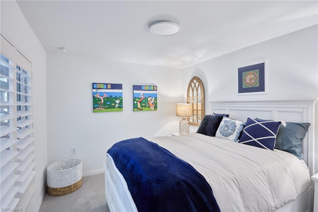 6070 National Blvd Avenue, Unit 226 Immokalee, FL 34142 - Photo 23 of 47 a bedroom with a bed and a painting on the wall