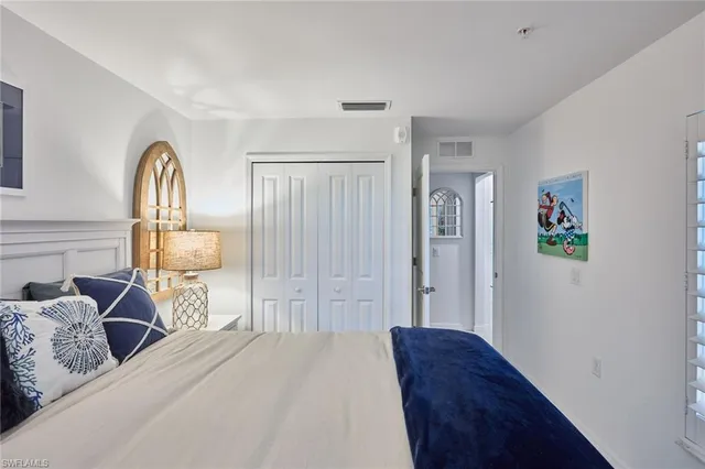 a bedroom with a bed and a painting on the wall