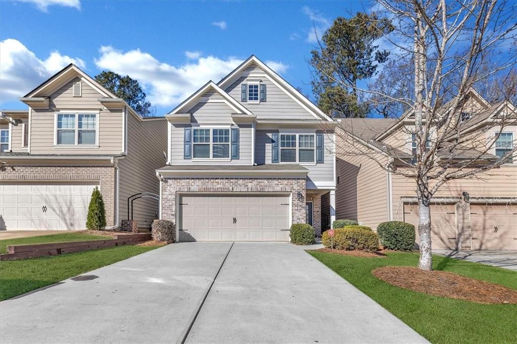 a front view of a house with a yard and garage