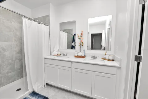 a bathroom with 2 sink and a mirror