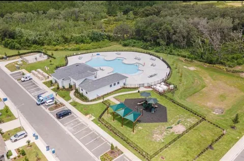 an aerial view of a house with a swimming pool