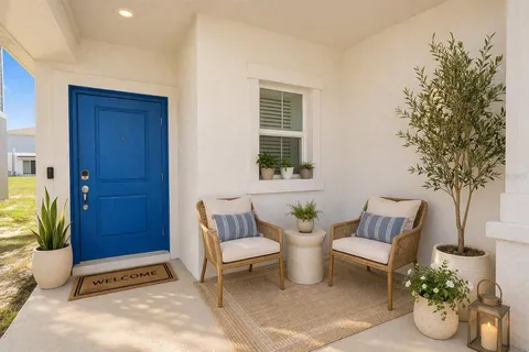a view of a house with backyard and sitting area