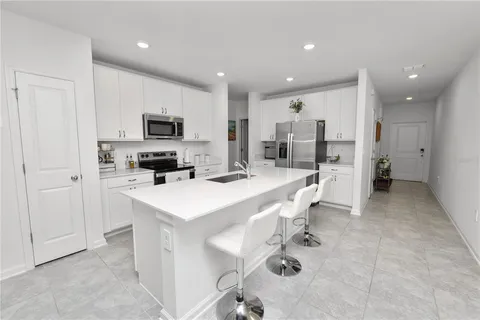 a kitchen with a sink a counter top stainless steel appliances and cabinets