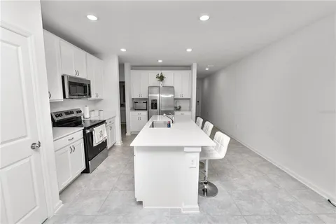 a kitchen with a sink stainless steel appliances and cabinets