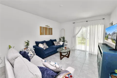 a living room with furniture and a large window