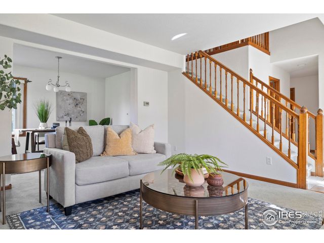a living room with furniture and a dining table