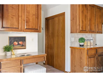 a kitchen with stainless steel appliances granite countertop a refrigerator and a wooden cabinets