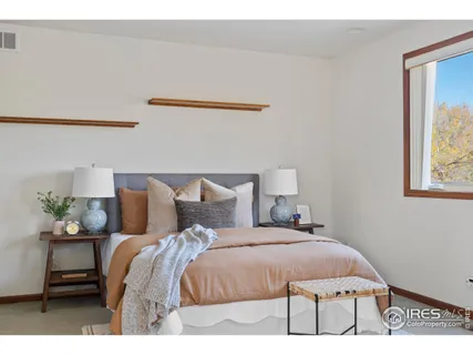 a bed sitting in a bedroom next to a window